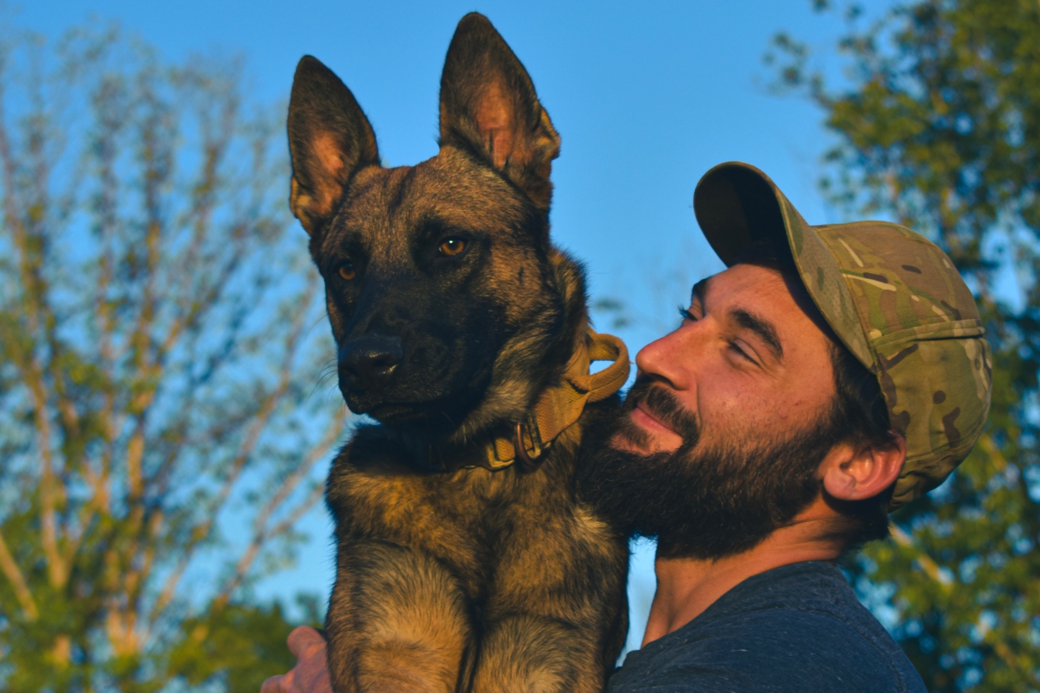 Joshua with his canine partner Cali outdoors
